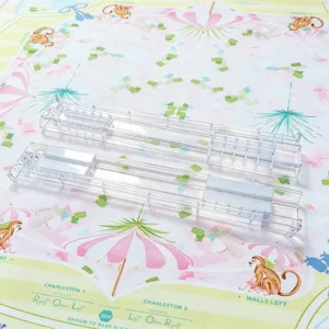 Set of clear acrylic Mahjong tile racks on a decorative table surface