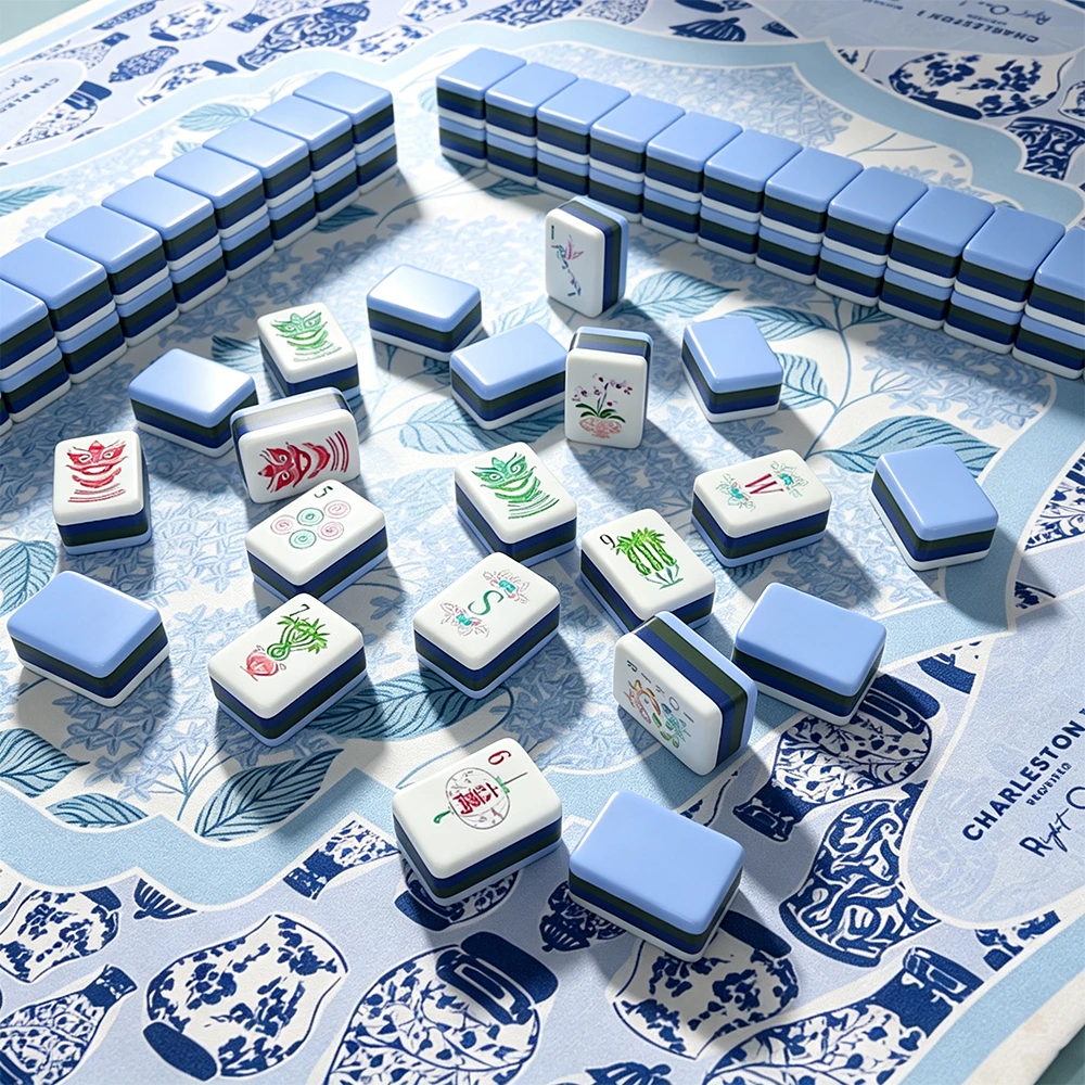 Close-up of peacock blue mahjong tiles on floral table setting