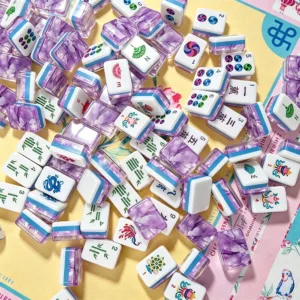 Scattered purple marble acrylic mahjong tiles close-up display