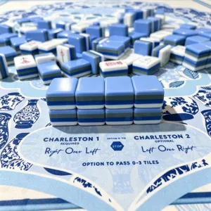 Peacock blue mahjong tile set with packaging box on floral table setting