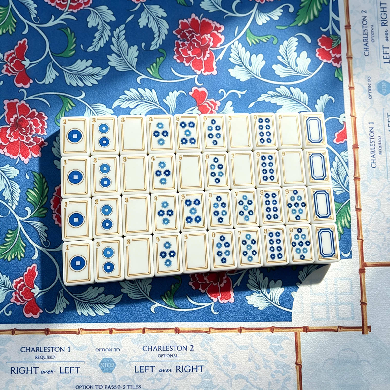 Sapphire Trail acrylic Mahjong tiles arranged on a blue floral game mat