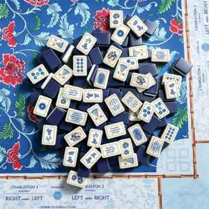 Sapphire Trail blue and ivory acrylic Mahjong tiles displayed on a floral game mat